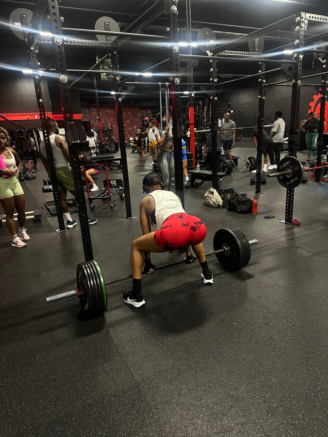 Color photo of Nikki mid-deadlift at the gym