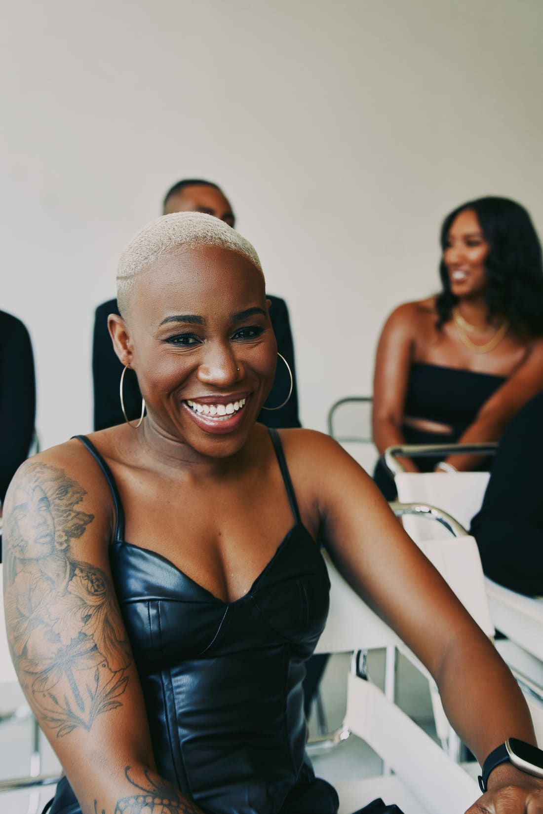 Color candid of Nikki laughing in a black leather top
