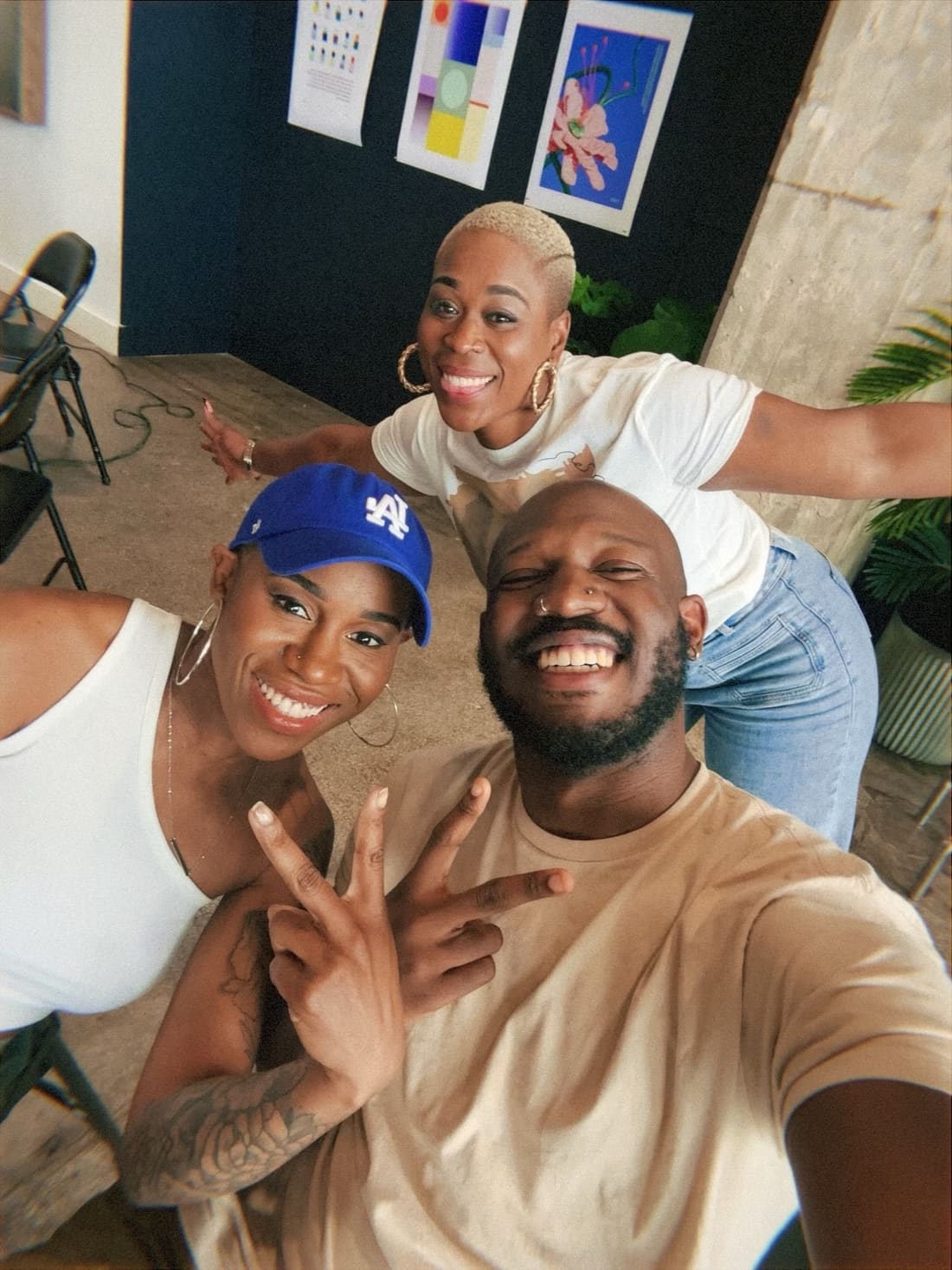 Color selfie of Nikki and two friends goofing around in a studio
